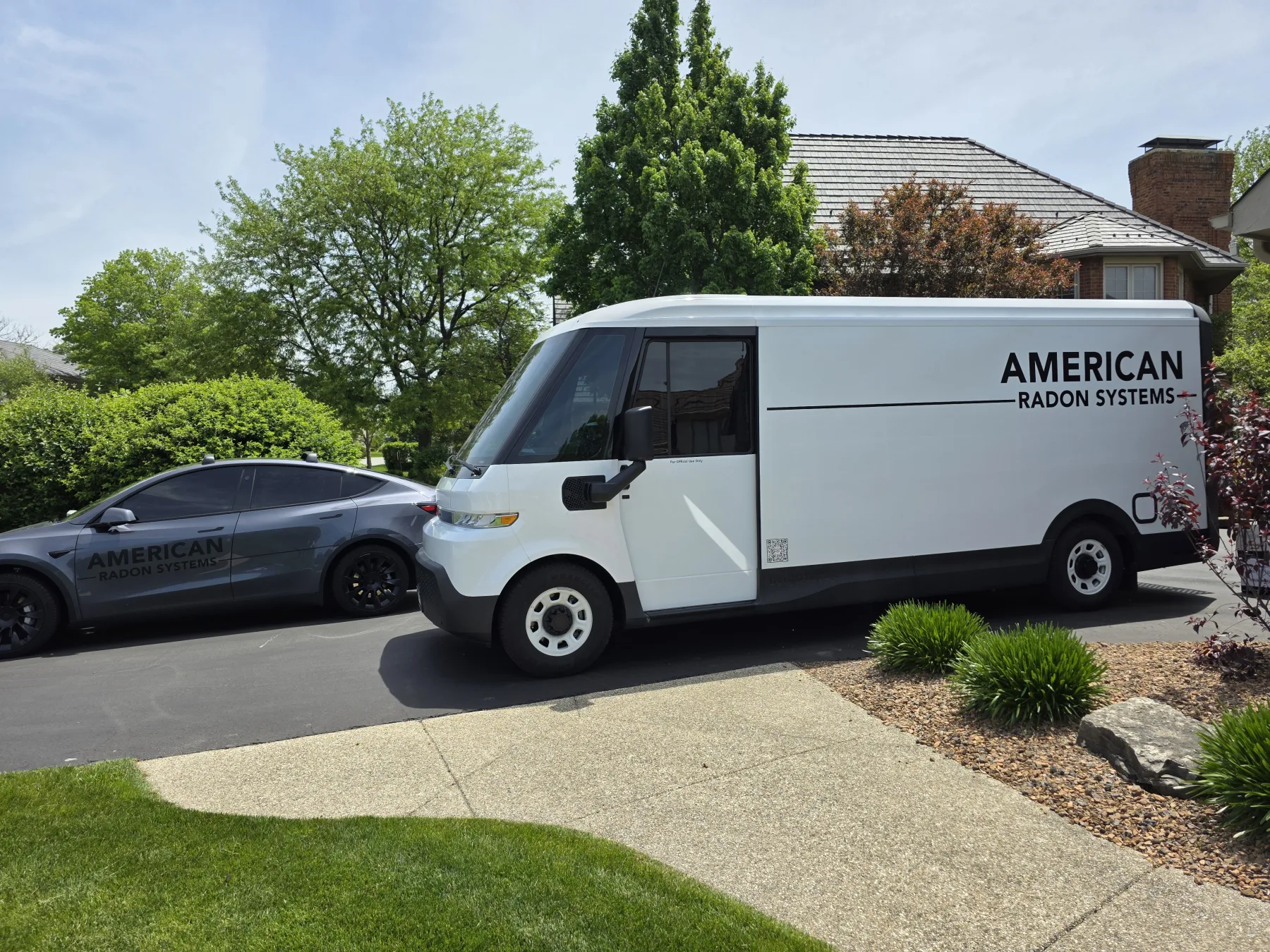 The American Radon Systems van and service vehicle in a customer's driveway